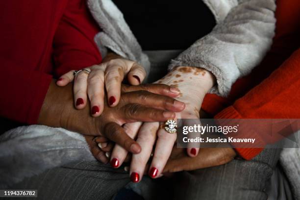 two mature woc holding hands - fayetteville stock pictures, royalty-free photos & images