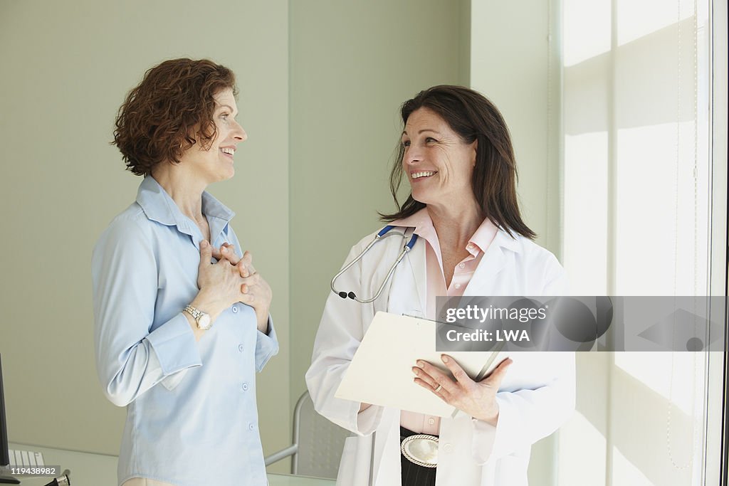 Relieved Woman Receiving Good News From Doctor