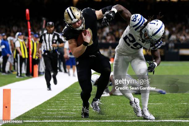 Taysom Hill of the New Orleans Saints scores a touchdown over free safety Malik Hooker of the Indianapolis Colts in the third quarter of the game at...