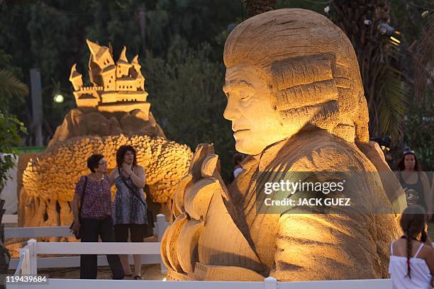 Israelis visit the Tales in Sand Exhibition in the Eretz Israel Museum in Tel Aviv, on July 20, 2011. Eighteen giant sand sculptures, each about 4...