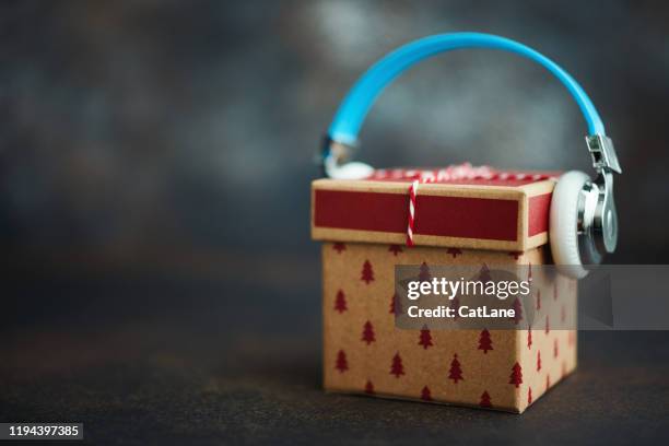 christmas gift with headphones. gift of music - christmas music stock pictures, royalty-free photos & images