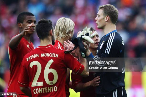 Goalkeeper Manuel Neuer of Muenchen celebrates with team mates after winning the penalty shootout during the LIGA total! Cup 3rd place match between...