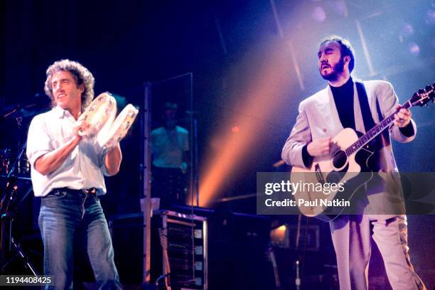 English Rock musicians Roger Daltry , on vocals, and Pete Townshend, on guitar, both of the group the Who, perform onstage at the Glens Falls Civic...