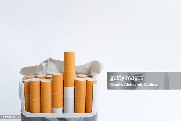 an open pack of cigarettes stands upright on a white background. space for text. - cigarette stock-fotos und bilder