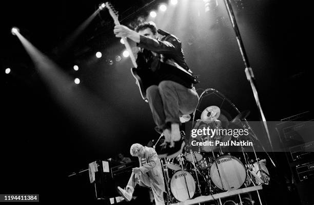 English Rock musician Pete Townshend , of the group the Who, jumps as he plays guitar during a performance onstage at the Rosemont Horizon, Rosemont,...
