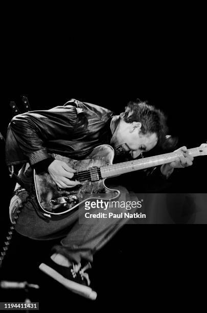 English Rock musician Pete Townshend, of the group the Who, jumps as he plays guitar during a performance onstage at the Rosemont Horizon, Rosemont,...