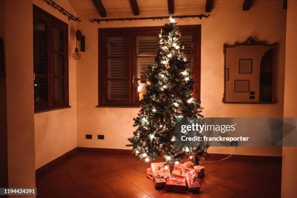 christmas tree home interior - christmas presents under tree stock pictures, royalty-free photos & images