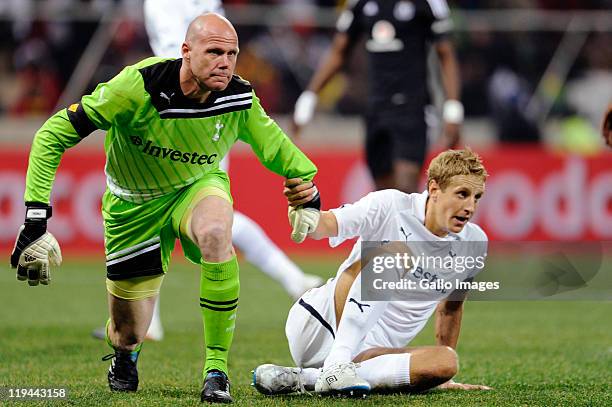 Goalkeeper Brad Friedel and Michael Dawson of Tottenham Hotspur in action during the 2011 Vodacom Challenge match between Orlando Pirates and...