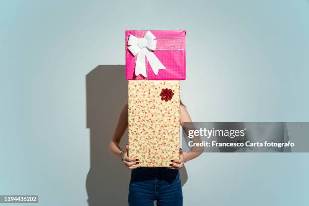 woman hidden behind gifts - pile of gifts stock pictures, royalty-free photos & images