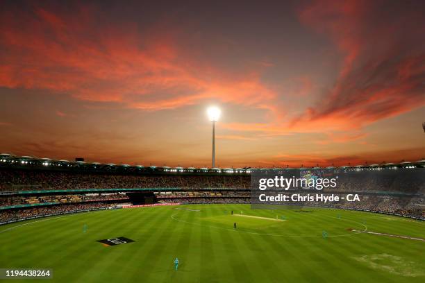 The sun sets during the Big Bash League match between the Brisbane Heat and the Sydney Thunder at The Gabba on December 17, 2019 in Brisbane,...