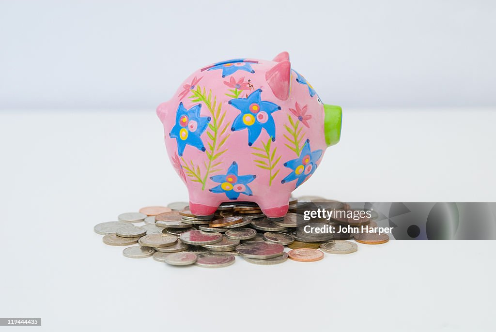 Piggy bank on pile of coins.