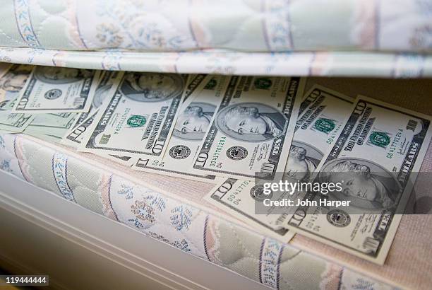 american dollars under mattress. - hiding money stock pictures, royalty-free photos & images