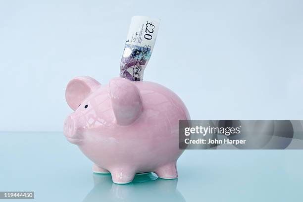 twenty pounds and piggy bank. - twenty pound note stock pictures, royalty-free photos & images