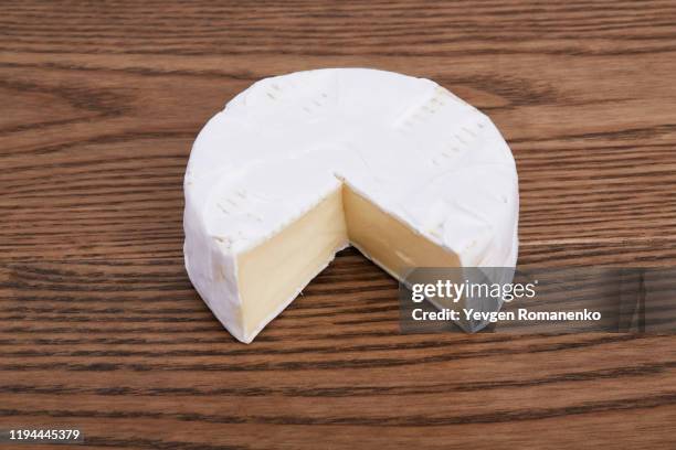 camembert cheese on a wooden background - brie stock pictures, royalty-free photos & images