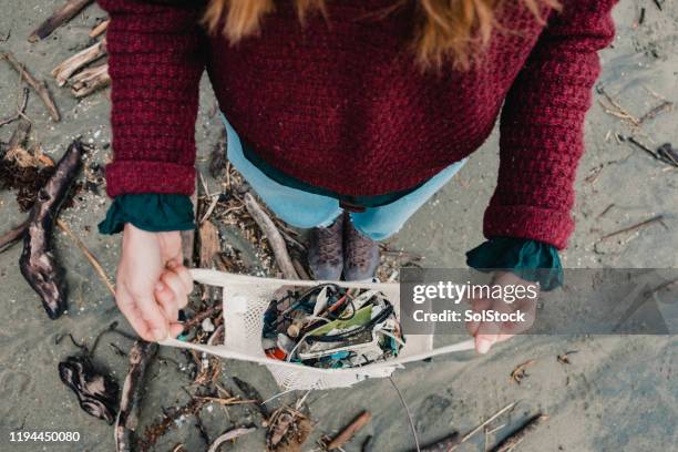 rubbish collection at the beach - sustainable tourism stock pictures, royalty-free photos & images