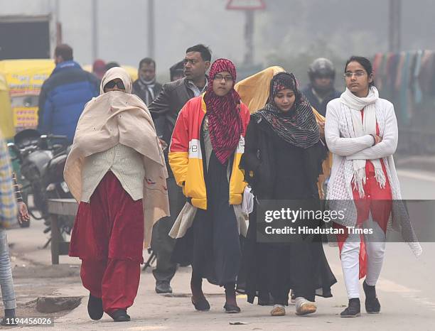 Commuters seen in warm clothes on a cold foggy winter morning, at Turkman Gate, on January 18, 2020 in New Delhi, India. The maximum temperature in...