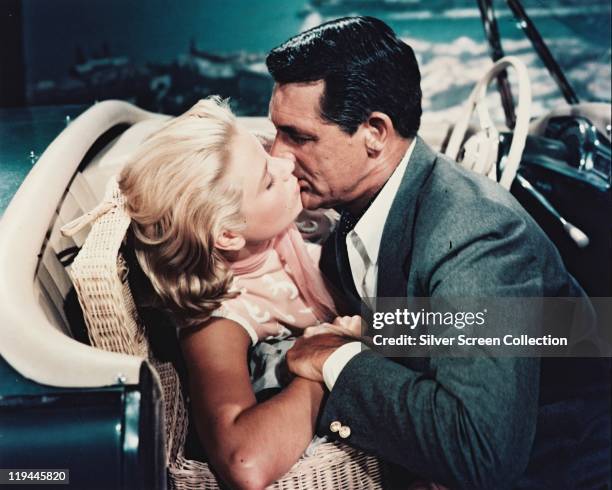 Grace Kelly and Cary Grant kissing in the front seat of a car in a publicity still issued for the film, 'To Catch a Thief', 1955. The 1955 film,...