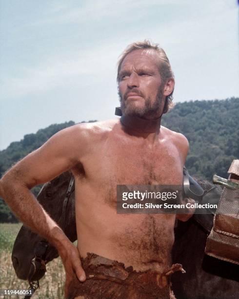 Charlton Heston , US actor, bare-chested with a restraint attached to his neck in a publicity portrait issued for the film, 'Planet of the Apes',...