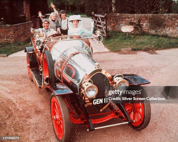 Dick Van Dyke, Heather Ripley, Adrian Hall and Sally Ann Howes sit waving from their seats in the car, in a publicity portrait issued for the film ,...