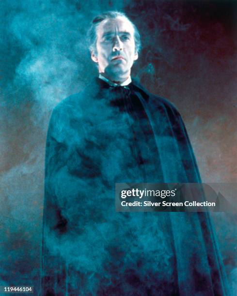 Christopher Lee, British actor, in costume and enveloped in smoke in an atmospheric publicity portrait issued for the film, 'Dracula Has Risen from...