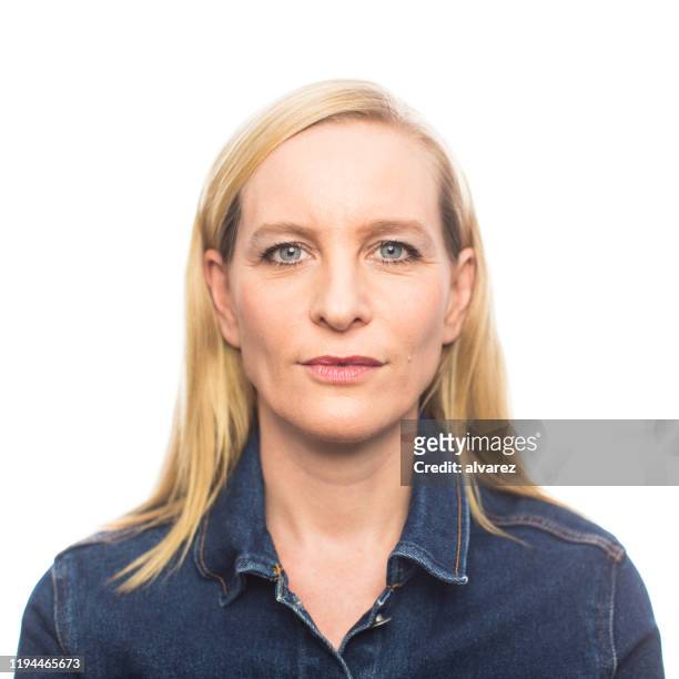 mature woman in casuals staring at camera - formal portrait serious stock pictures, royalty-free photos & images