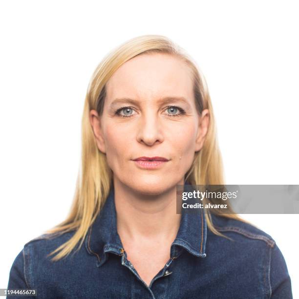 mature woman in casuals staring at camera - northern european plain stock pictures, royalty-free photos & images