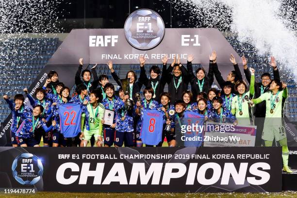 Nakajima Emi of Japan rises up the trophy and celebrate the champion with teammates during the ceremony of the EAFF E-1 Football Championship match...