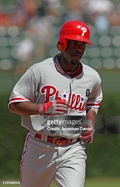 Jimmy Rollins of the Philadelphia Phillies runs the bases after hitting the first of two home run against the Chicago Cubs at Wrigley Field on July...