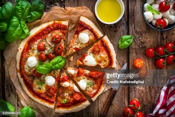 italian food: delicious homemade pizza with mozzarella and cherry tomatoes - cheese pizza stock pictures, royalty-free photos & images