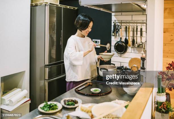 asian woman cooking in the kitchen - japan food stock pictures, royalty-free photos & images