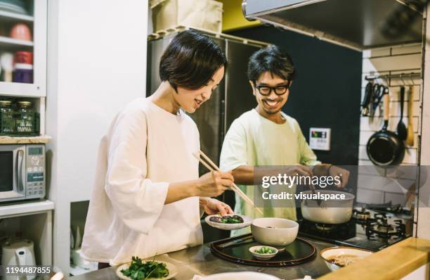 asian couple in preparing food in the kitchen - japan food stock pictures, royalty-free photos & images