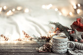 Festive background with Cup on wooden background with lights.