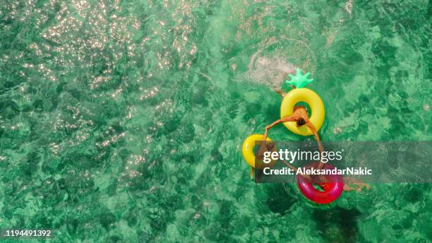 happy family in the sea - inflatable stock pictures, royalty-free photos & images