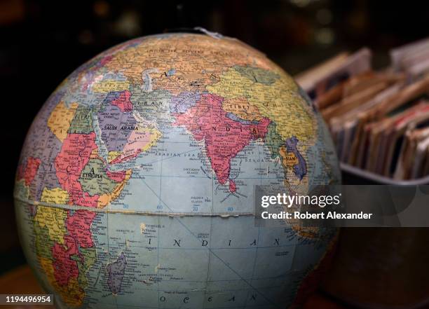 Vintage globe of the world for sale in an antique shop showing the Indian Ocean and surrounding countries including India, the eastern coast of...