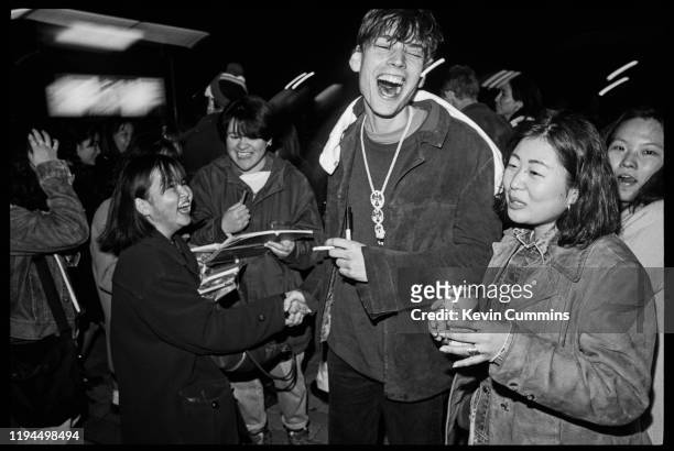 English musician and songwriter Alex James of rock band Blur with fans in Tokyo, Japan, March 1992.
