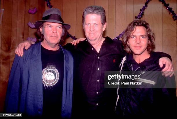 Portrait, from left, of Canadian Rock and Folk musician Neil Young, and American Rock and Pop musicians Brian Wilson and Eddie Vedder as they pose...