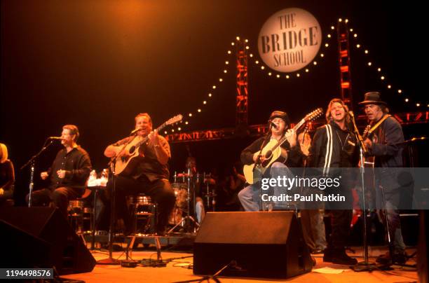 View of musicians, from left, Brian Wilson, Jeff Foskett, Nick Walusko, Eddie Vedder, and Neil Young as they perform onstage during the Bridge School...