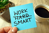 Work smart - motivational reminder handwritten on sticky note