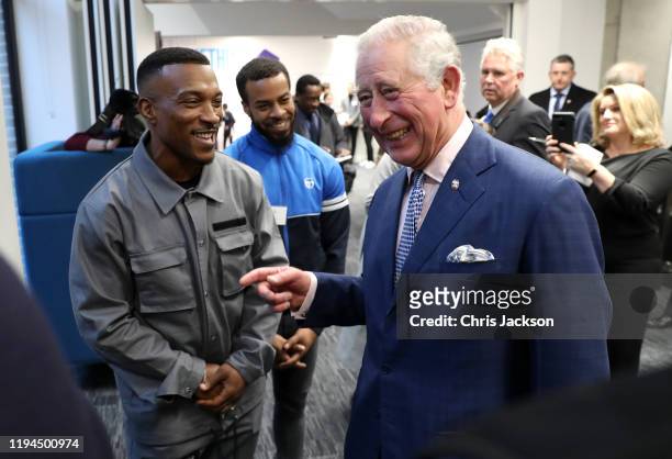 Prince Charles, Prince of Wales shares a joke with Ashley Walters at the opening of the Prince's Trust new South London Centre on December 17, 2019...