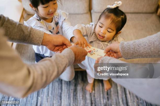 grandfather giving otoshidama money - new year japan stock pictures, royalty-free photos & images