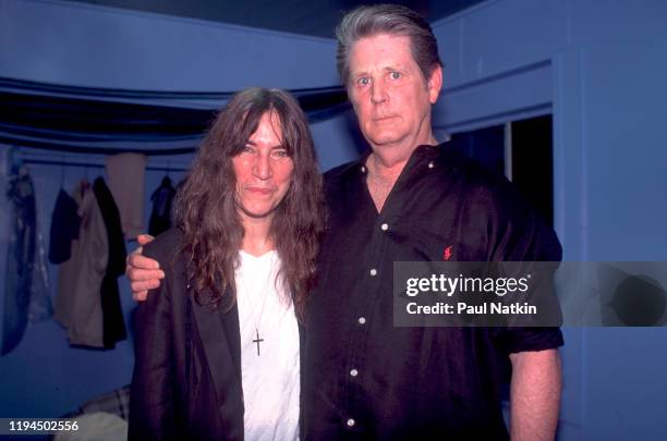 American Rock musician and poet Patti Smith and Rock and Pop musician Brian Wilson pose together backstage at the Roxy Theater, Los Angeles,...