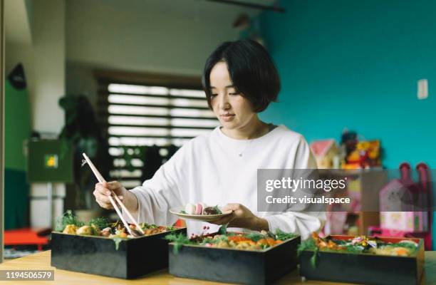 preparing for dinner - osechi ryori stock pictures, royalty-free photos & images