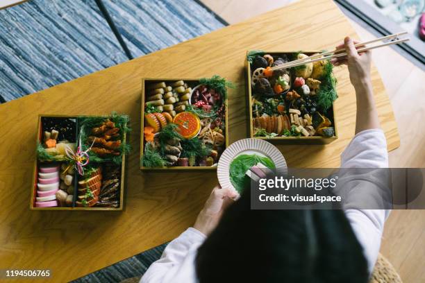 preparing for dinner - osechi ryori stock pictures, royalty-free photos & images