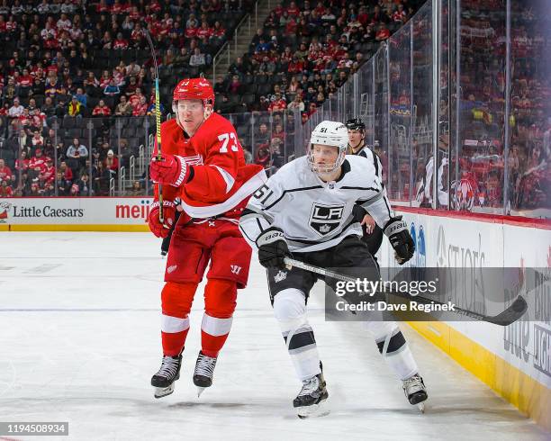 Adam Erne of the Detroit Red Wings tries to skate by the defense of Austin Wagner of the Los Angeles Kings during an NHL game at Little Caesars Arena...