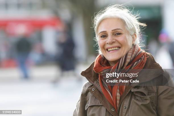 older lady in street, smiling - devon winer stock-fotos und bilder