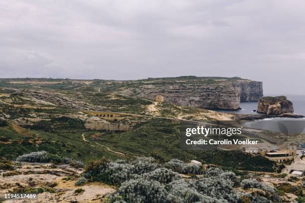 tourist sight of the azure window from a high vantage point in san lawrenz, gozo, malta - azure window malta stock pictures, royalty-free photos & images