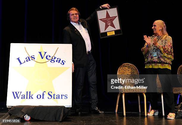Singer Engelbert Humperdinck holds a small version of his star at the Paris Las Vegas during his Las Vegas Walk of Stars dedication ceremony as his...