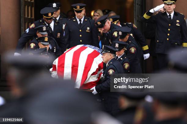 The casket for New Jersey Detective Joseph Seals is brought out of a church during his funeral on December 17, 2019 in Jersey City, New Jersey....