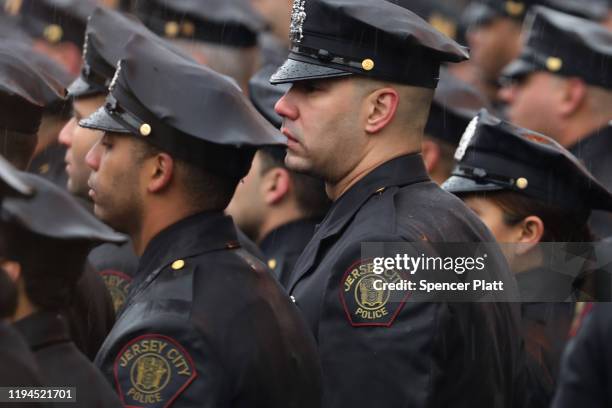 Thousands of police officers gather in the rain for the funeral service for New Jersey Detective Joseph Seals, who died last week in a shooting that...