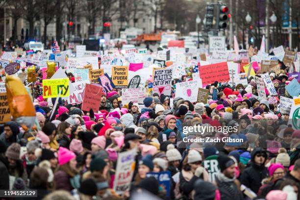 Demonstrators carry signs during the 2020 Women's March on January 18, 2020 in Washington, DC. Marches were held nationwide in cities including New...
